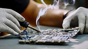 An engineer soldering a circuit