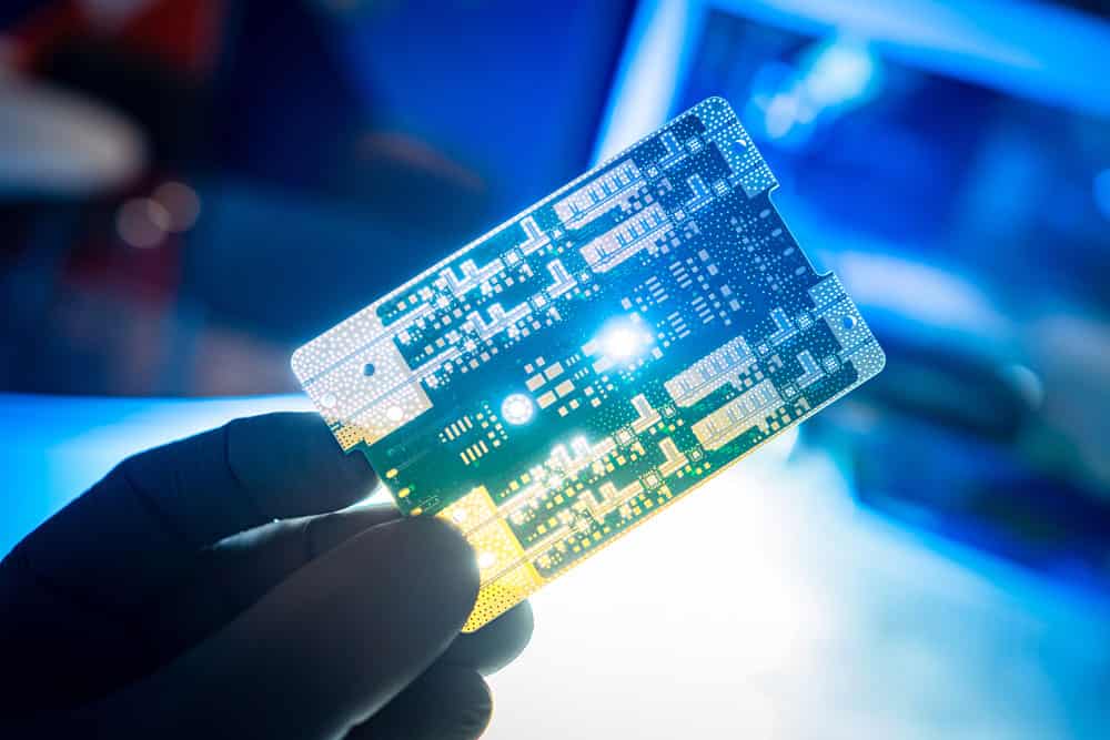 A man holding a designed PCB