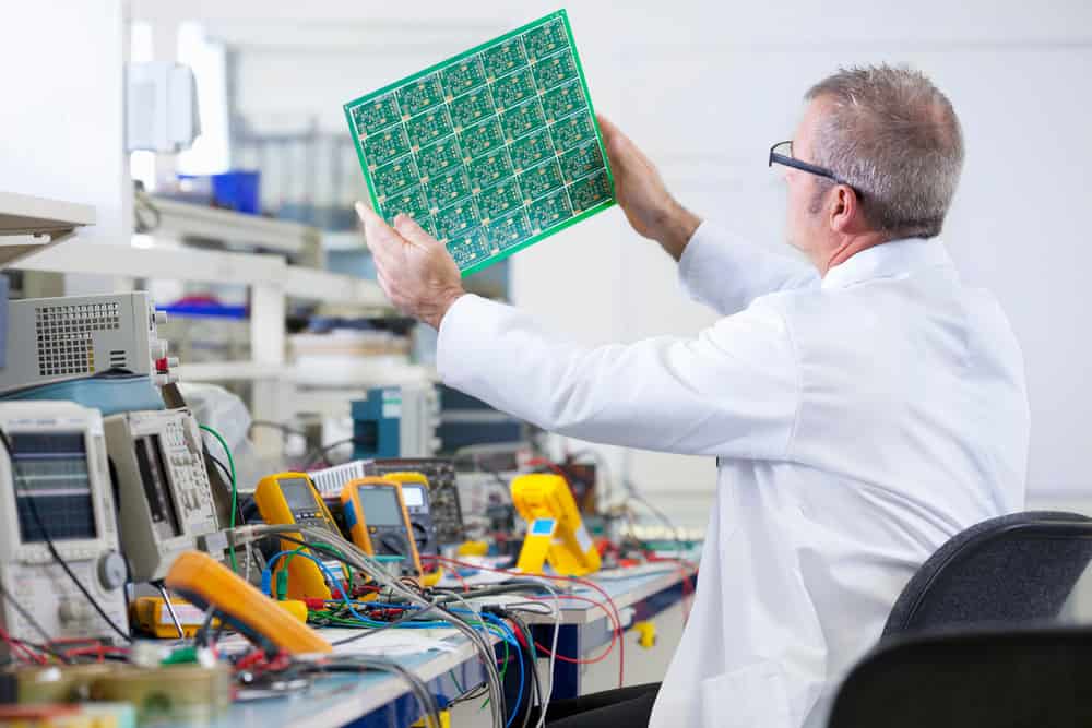 A man repairing a circuit board